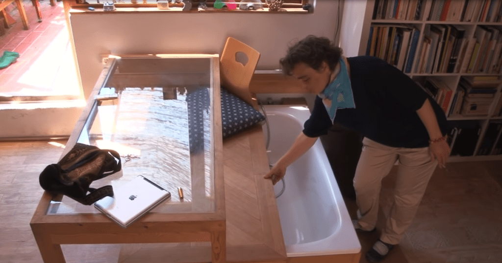 Architect constructs tiny apartment she can afford, hiding bathtub and