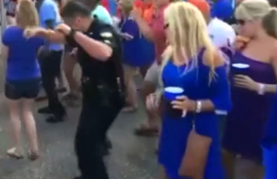 Cop can’t resist dancing along with the crowd when the Cupid Shuffle ...
