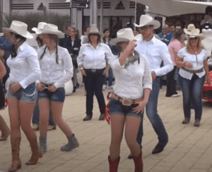 Cowboys And Girls Show Off Their Moves In Fun Line Dance