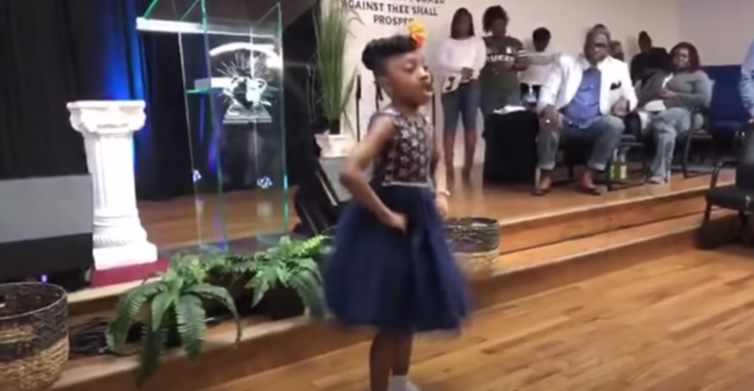 Little girl breaks out powerful praise dance in front of church